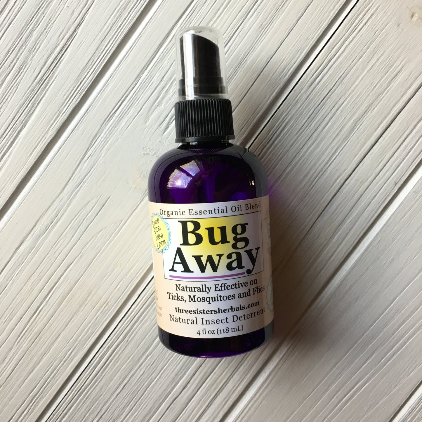 Bug Away organic essential oil blend bottle on a wooden surface