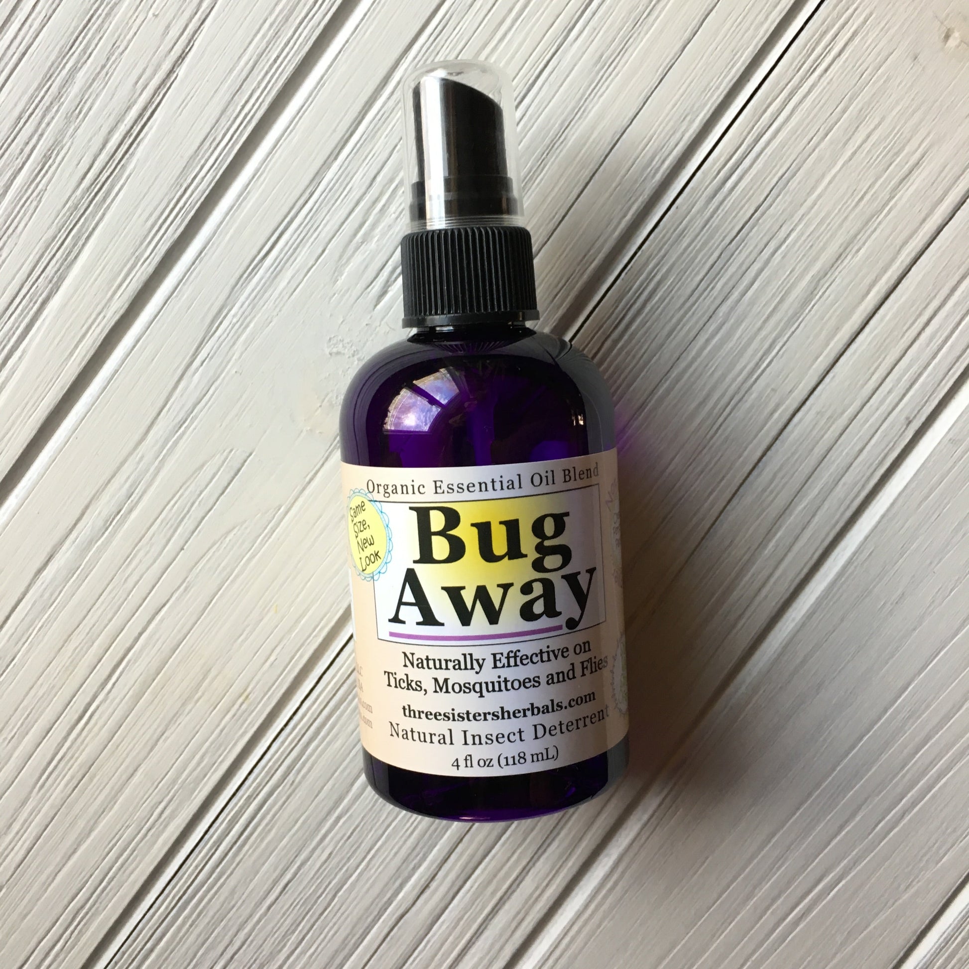 Bug Away organic essential oil blend bottle on a wooden surface