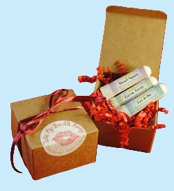 Kraft gift box with 3 organic essential oil inhalers. let it be, head space, germ away four thieves blend packed in red tissue paper